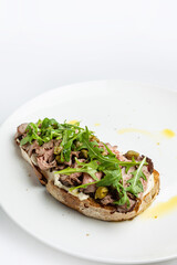 delicious bruschetta with cheese, meat, vegetables in a restaurant
