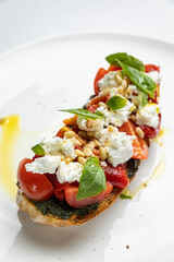 delicious bruschetta with cheese, meat, vegetables in a restaurant
