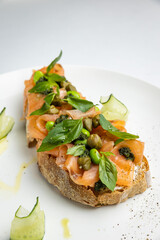 delicious bruschetta with cheese, meat, vegetables in a restaurant
