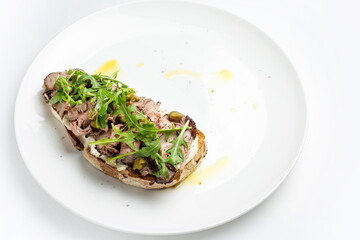 delicious bruschetta with cheese, meat, vegetables in a restaurant

