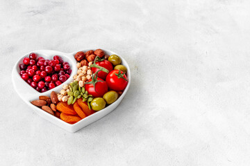 Diet cooking concept with healthy food in heart shaped plate