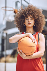 Portrait of a basketball player woman on a court holding a ball outdoors and ready for a sports...
