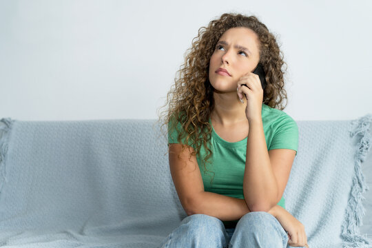 Beautiful young adult woman with phone waiting for assistance