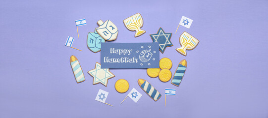 Composition with cookies and greeting card for Hanukkah on lilac background