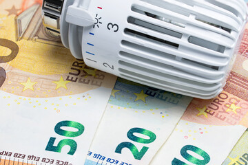 Heating thermostat on euro money banknotes. Temperature regulator.