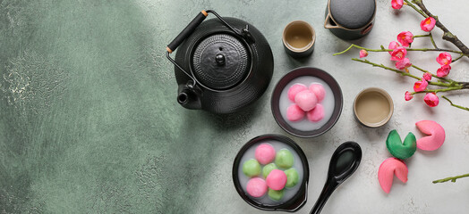 Bowls of tangyuan, fortune cookies and tea on grunge background with space for text. Dongzhi Festival