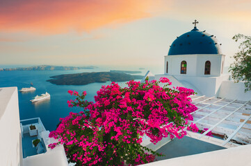 Santorini island, Greece. White architecture with pink flowers at sunset. - obrazy, fototapety, plakaty