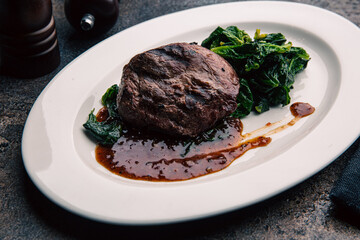 Beef steak with green salad and sauce