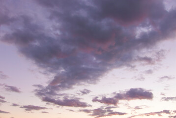 Pink purple clouds in the sky at dusk