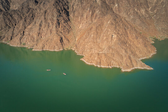 Aerial View of Kayakers paddling in beautiful mountain lake in Hatta, Dubai