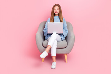 Full body photo of young focused confident teenager girl junior coder sit couch chair hold laptop...