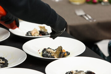 The chef serving Italian risotto. Shrimp, white wine, rice, onions, thyme, garlic.