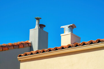 Dual chimney on a cityscape in the suburban area of the historic districts of San Francisco California in the late afternoon sun