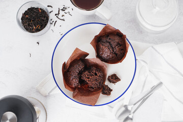 Plate of sweet chocolate muffins on light table