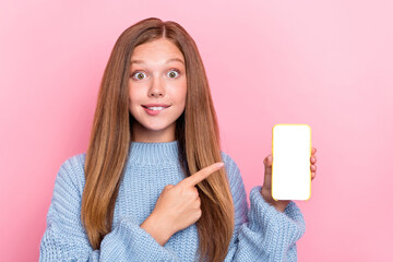 Photo of impressed excited shocked lady user blogger arm direct empty space recommend new cool gadget isolated on pink color background