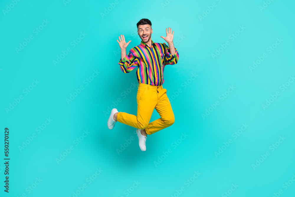 Poster Full size photo of positive good mood guy brunet haircut wear colorful shirt raise palms up flying isolated on teal color background