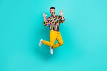 Full size photo of positive good mood guy brunet haircut wear colorful shirt raise palms up flying isolated on teal color background