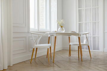 Interior of contemporary light room with white walls and big windows round table with two chairs...