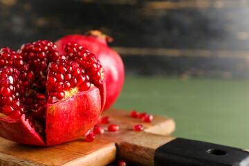 Cutting board with fresh pomegranates, closeup