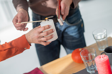 Couple lighting the candles on occasion of anniversary