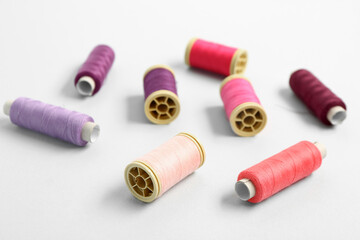 Set of colorful thread spools on light background