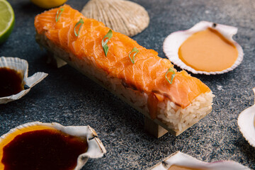 Sushi with salmon and assorted sauces