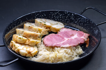 smoked meat served with sauerkraut and dumplings