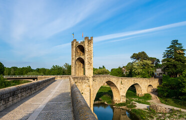 Fototapeta na wymiar Panoramic landscape of Medieval village and castle in Besalu, Costa Brava, Spain. Besalu is a famous tourist destination in Spain, South Europe. Nice place for tourism near Mediterranean Sea