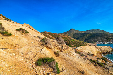Fototapeta na wymiar Natural rock formations of yellow cliffs on low sunlight, Milos