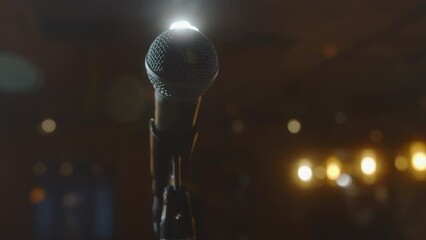 Microphone in bright light. An empty hall without spectators. Concert hall scene. Waiting for the performance of an artist, singer, politician. World crisis, financial losses