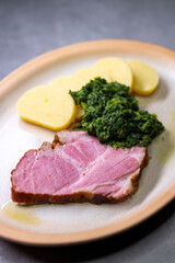 smoked meat with spinach and potato dumplings