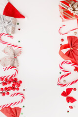 Composition with Christmas decorations and candy canes on white background