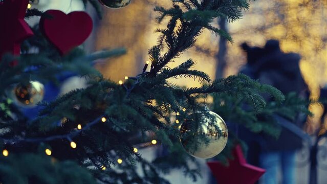 Outdoor Christmas Tree Lights And Decoration On The Street In Christmas Fair. Slow Motion Video Shallow Depth Of Field Unrecognizable People.