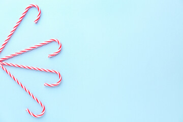 Composition with tasty candy canes on color background