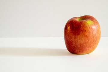 A fresh red apple on a white background.