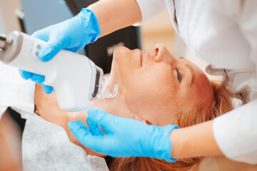 Obraz na płótnie Canvas Fractional laser resurfacing is a unique technique for skin rejuvenation - laser resurfacing removes micro-sections of old skin with the subsequent formation of new young and healthy skin
