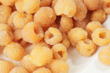 Ripe yellow raspberries as background close-up.