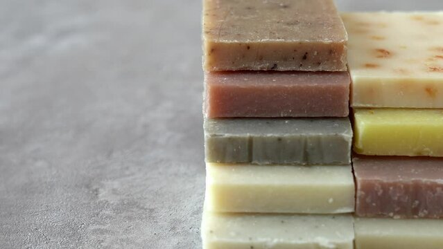 Camera movement on folded pieces natural healing soap different types. Spa, bath, bathroom. Skin care. Clay, sea salt, therapeutic mud, herb
