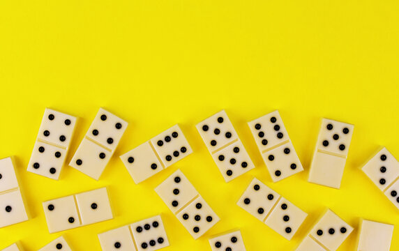 White dominoes on a yellow background
