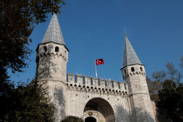Fototapeta na wymiar Topkapi Palace. Istanbul, Topkapi Palace entrance. Topkapi Palace entrance and towers Inscription on the entrance: “Sultan of two continents and ruler of two seas”