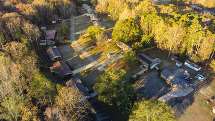 Fototapeta premium Aerial top view suburban residential houses with no fenced backyard and lush green tree from woodland Bogan Park in Buford, Georgia, USA