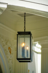 Hidden lantern on a secret porch or balcony near house or home with burning candles and black paint...