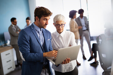 Group of multiethnic successful business people working and communicating at the office