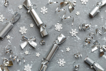 Christmas crackers with shiny confetti on color background, top view, copy space