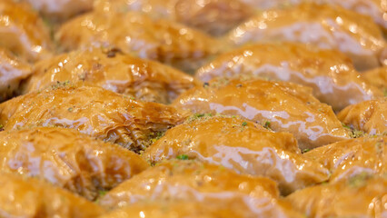 Traditional Dessert Turkish Baklava. Walnut, Pistachio Turkish Style Antep Baklava Presentation. Baklava from Turkish cuisine. Close up, selected focus, swollow deep
