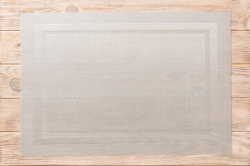 Top view of grey tablecloth for food on wooden background. Empty space for your design