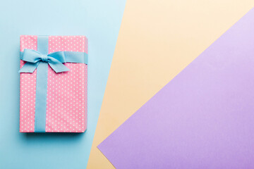holiday handmade paper present tied blue ribbon bow top view with copy space. Flat lay holiday background. Birthday or christmas present. Christmas gift box concept with copy space