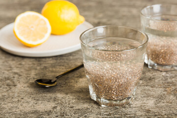Healthy breakfast or morning with chia seeds and lemon on table background, vegetarian food, diet and health concept. Chia pudding with lemon