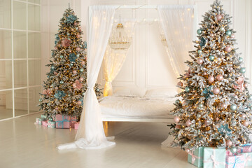 Modern white bedroom in Skandinavian style with bed with flowing white curtains and two decorated christmas tree. Concept new year and holidays. Interior design bedroom. Winter Xmas Hygge home decor	