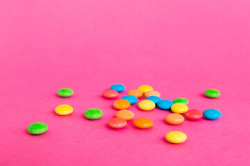 Pile of delicious colorful sweet candies on colored background top view. Confectionery decor